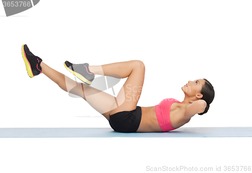 Image of beautiful sporty woman doing exercise