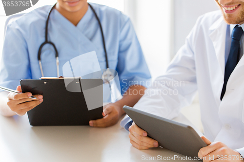 Image of doctors with tablet pc and clipboard at hospital
