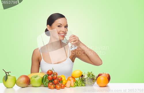 Image of woman with fruits and vegetables drinking water