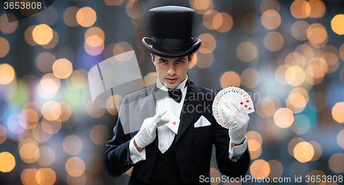 Image of magician showing trick with playing cards