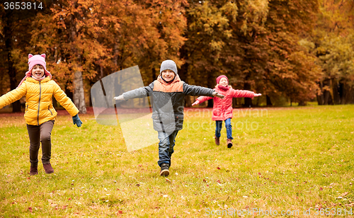 Image of happy little children running and playing outdoors
