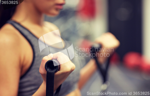 Image of close up of woman exercising on gym machine
