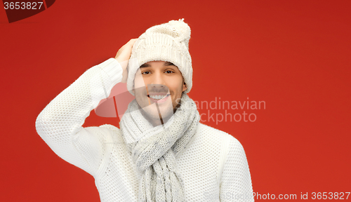 Image of handsome man in warm sweater, hat and scarf