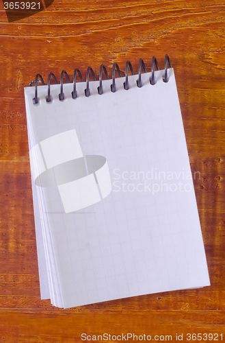 Image of note on wooden background