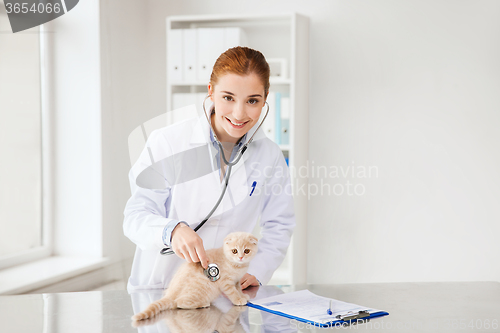 Image of happy veterinarian with kitten at vet clinic