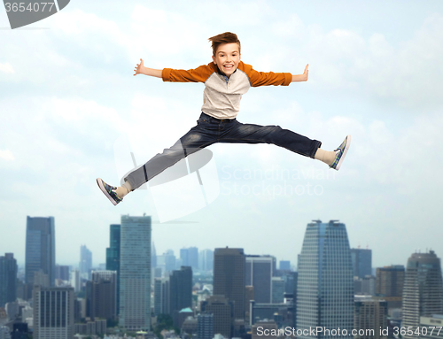 Image of happy smiling boy jumping in air