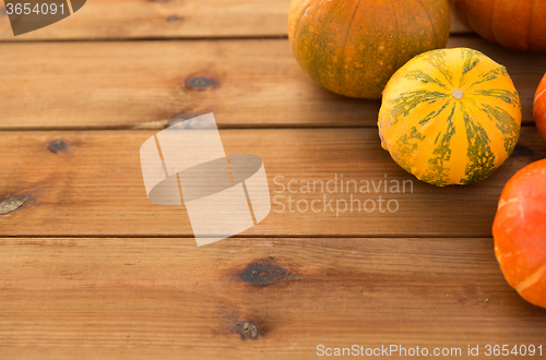 Image of close up of pumpkins on wooden table at home