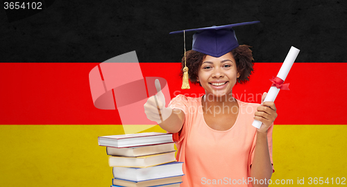 Image of happy bachelor girl with diploma showing thumbs up