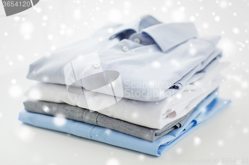 Image of close up of ironed and folded shirts on table