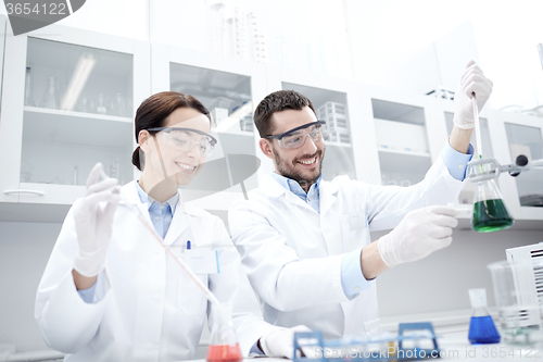 Image of young scientists making test or research in lab