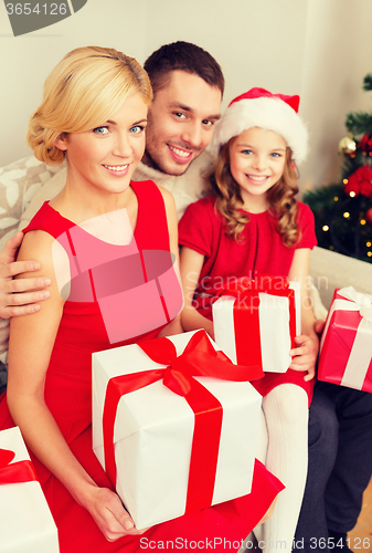 Image of smiling family holding many gift boxes