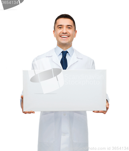 Image of smiling male doctor holding white blank board