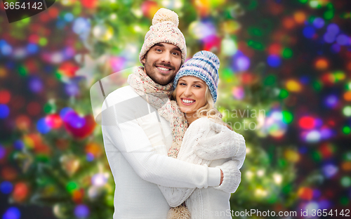 Image of smiling couple in winter clothes hugging