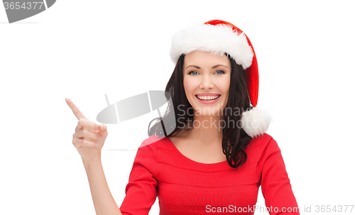 Image of woman in santa helper hat pointing to something