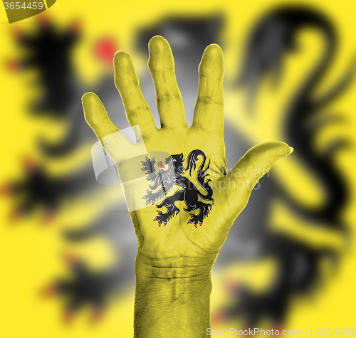 Image of Palm of a woman hand, painted with flag