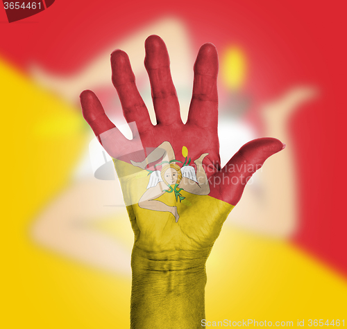 Image of Palm of a woman hand, painted with flag