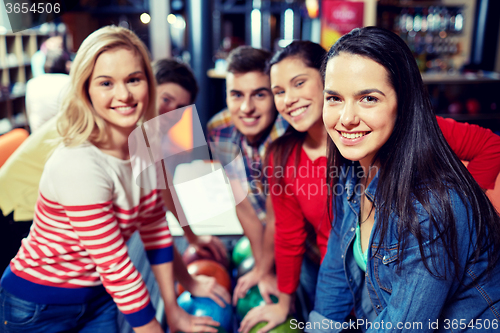 Image of happy friends in bowling club