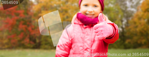 Image of happy girl showing thumbs up over autumn park