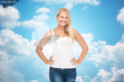 Image of smiling young woman in blank white shirt and jeans