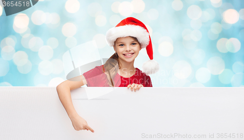 Image of child in santa helper hat with blank white board