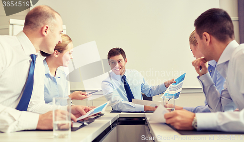 Image of group of smiling businesspeople meeting in office