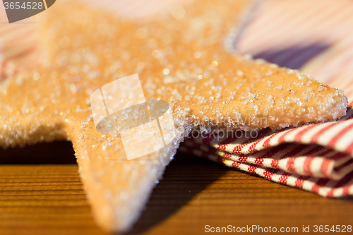 Image of close up of star gingerbread cookie and towel