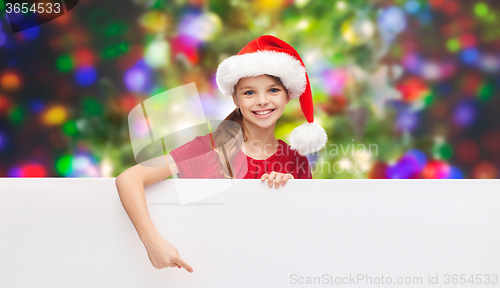 Image of child in santa helper hat with blank white board