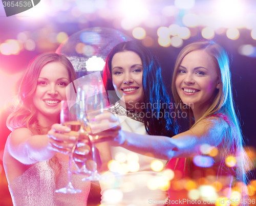 Image of smiling women with champagne glasses at night club