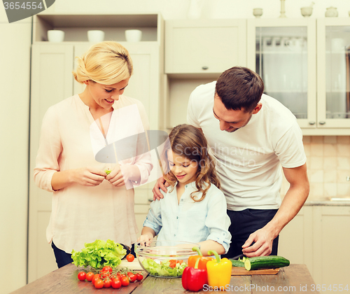 Image of happy family making dinner in kitchen