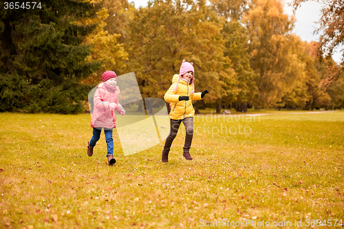 Image of group of happy little girls running outdoors