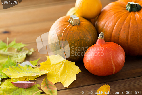 Image of close up of pumpkins on wooden table at home