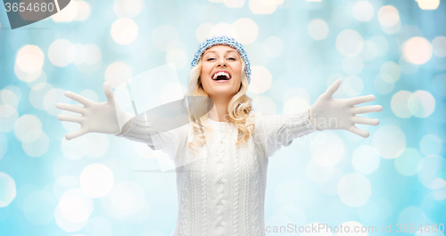 Image of smiling young woman in winter hat and sweater