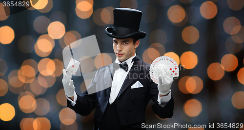 Image of magician showing trick with playing cards