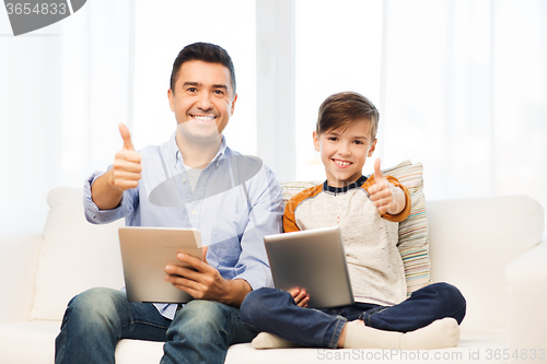 Image of father and son with tablet pc showing thumbs up