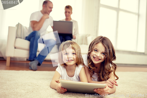 Image of happy little girls with tablet pc computer at home