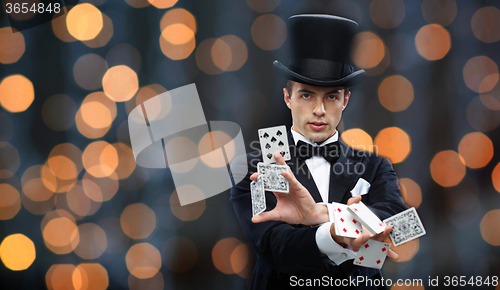 Image of magician showing trick with playing cards