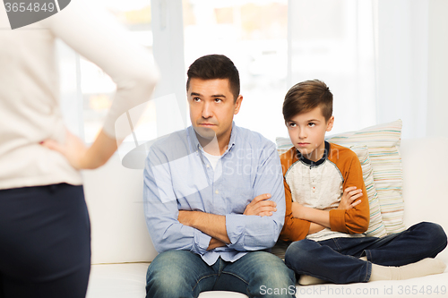 Image of upset or displeased father, son and mother at home