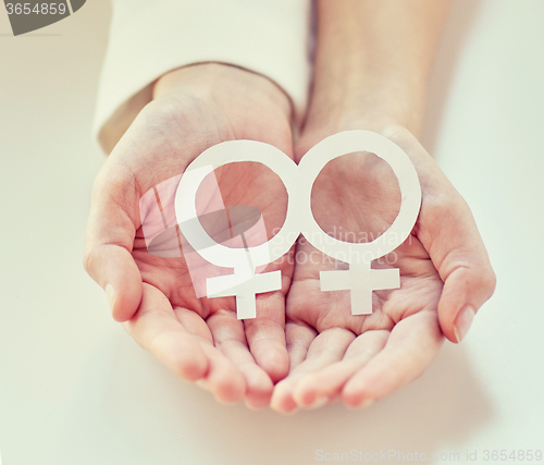 Image of close up of happy lesbian couple with venus symbol