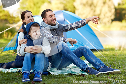 Image of happy family with tent at camp site