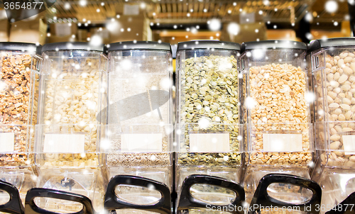 Image of row of jars with nuts and seeds at grocery store