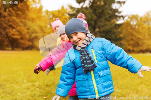 Image of group of happy children having fun in autumn park