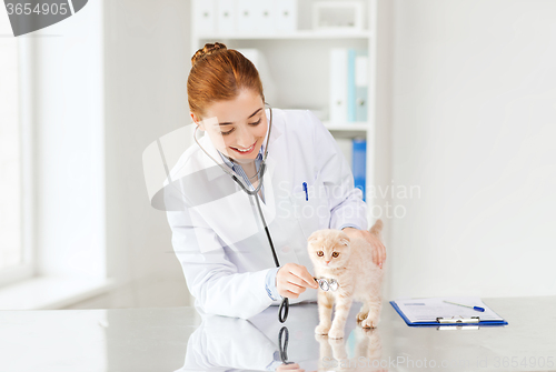 Image of happy veterinarian with kitten at vet clinic