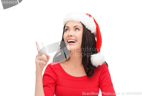 Image of woman in santa helper hat pointing to something