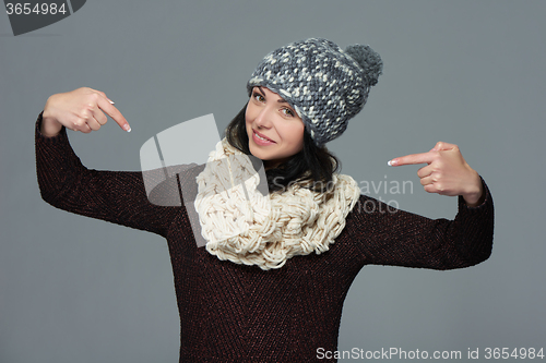 Image of Smiling woman pointing at herself