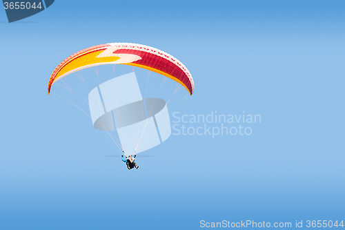 Image of Tandem paraglider free gliding in deep blue sky