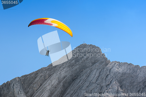 Image of Paraglider free soaring in cloudless sky over dolomites Alpine m