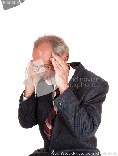 Image of Older man in suit with headache.