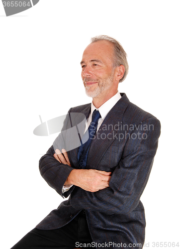 Image of Happy businessman with arms grossed.