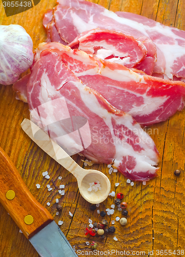 Image of Bacon with aroma spice on the wooden board