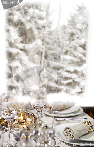 Image of Christmas dinner in front of winter forest